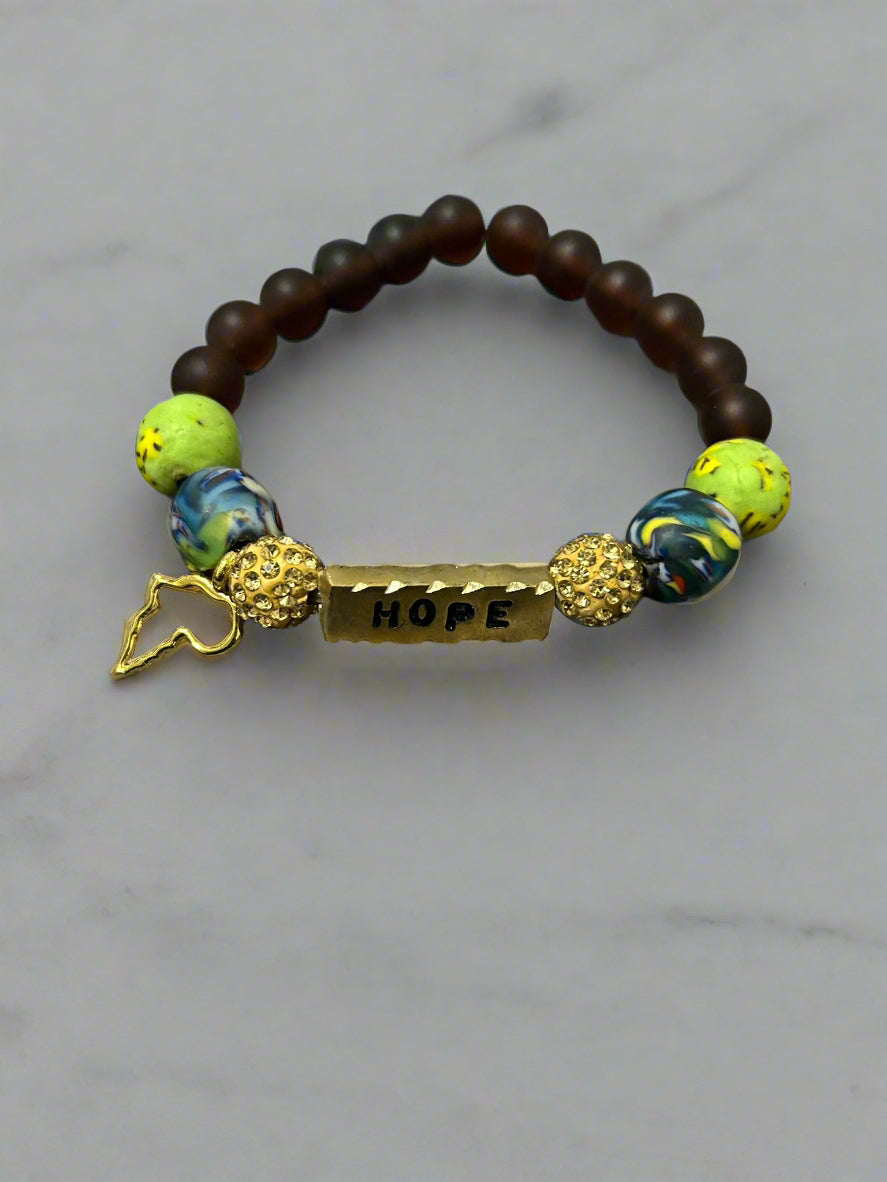 Bracelet with beads and 'HOPE' charm on a textured surface